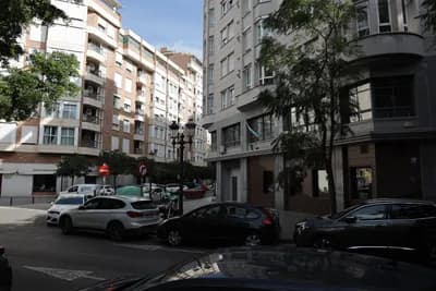 Parked cars and residential buildings in Valencia, Spain.