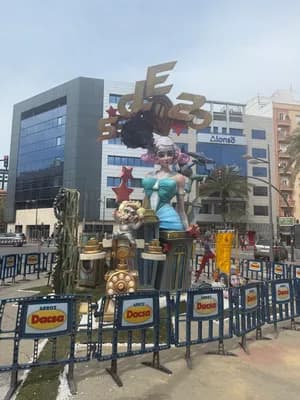 A vibrant float with a woman figurehead in an urban setting.