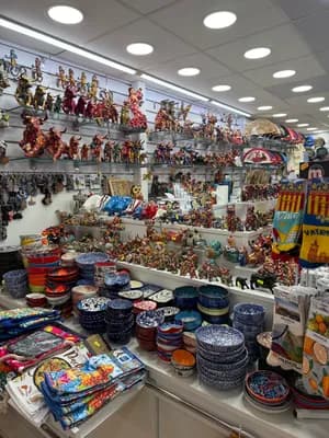 Store display with ceramic bowls and figurines.