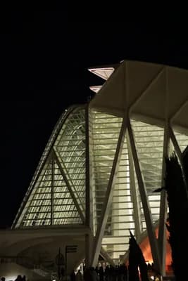 Illuminated modern architectural structures at night.