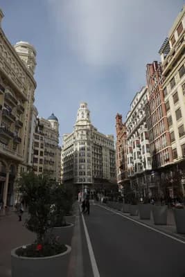 A street scene with tall buildings and a clear sky.