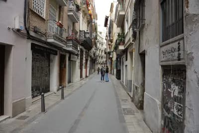 Narrow street with residential buildings in Valencia, Spain.