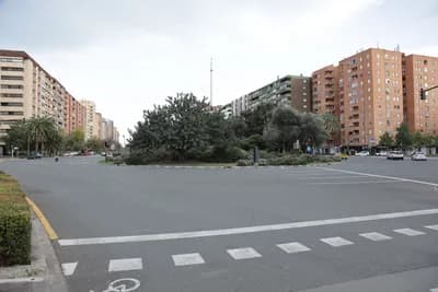 Urban intersection with high-rise buildings and trees.