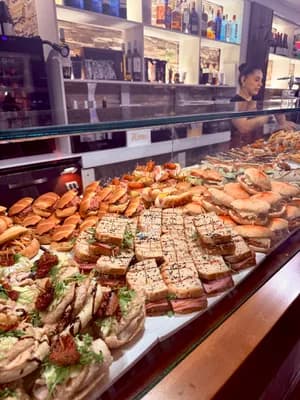 Display case with assorted sandwiches and pastries in a café.