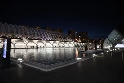 Modern architecture with a reflecting pool at night.