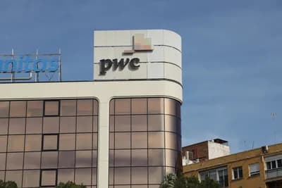 Modern building with PwC logo and glass windows.