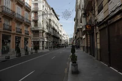 A street with ornate buildings and holiday decorations.
