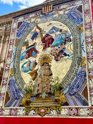 A vibrant mosaic featuring religious figures and floral arrangements.