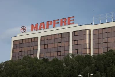Modern building with large windows and red 'MAPFRE' sign.