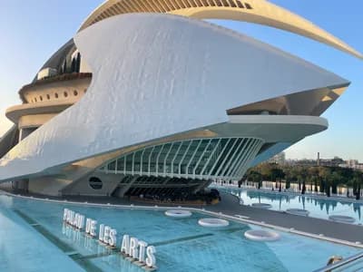 Futuristic building with a reflecting pool and modern architecture.