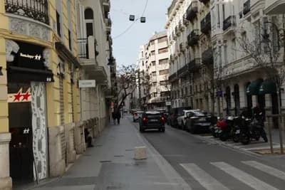 A street scene with parked motorcycles and ornate buildings.