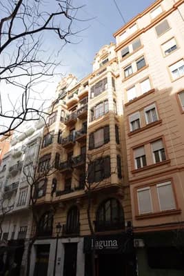 Residential buildings with balconies and a clear blue sky.